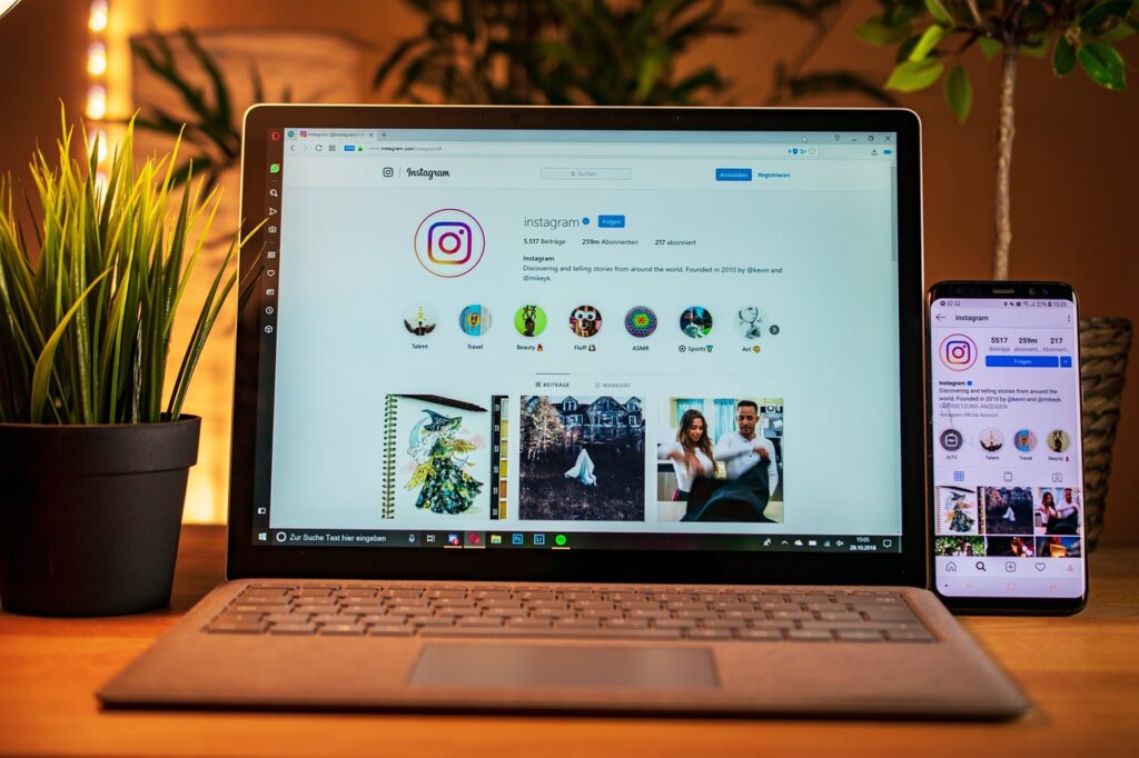 Laptop and phone with Instagram logo on the screens.