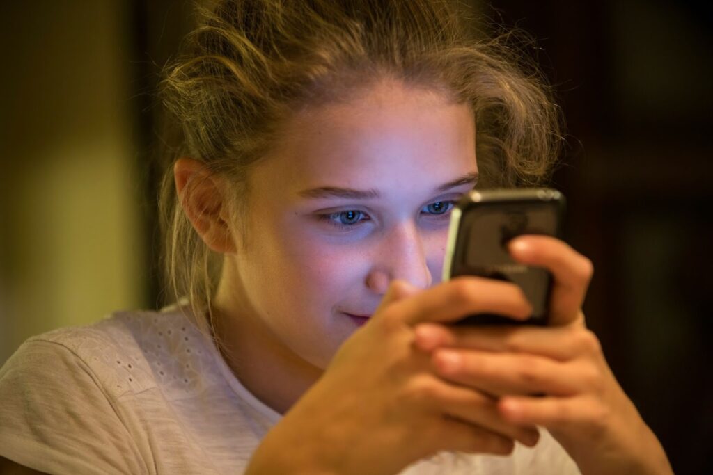 Teenage girl looking at her phone
